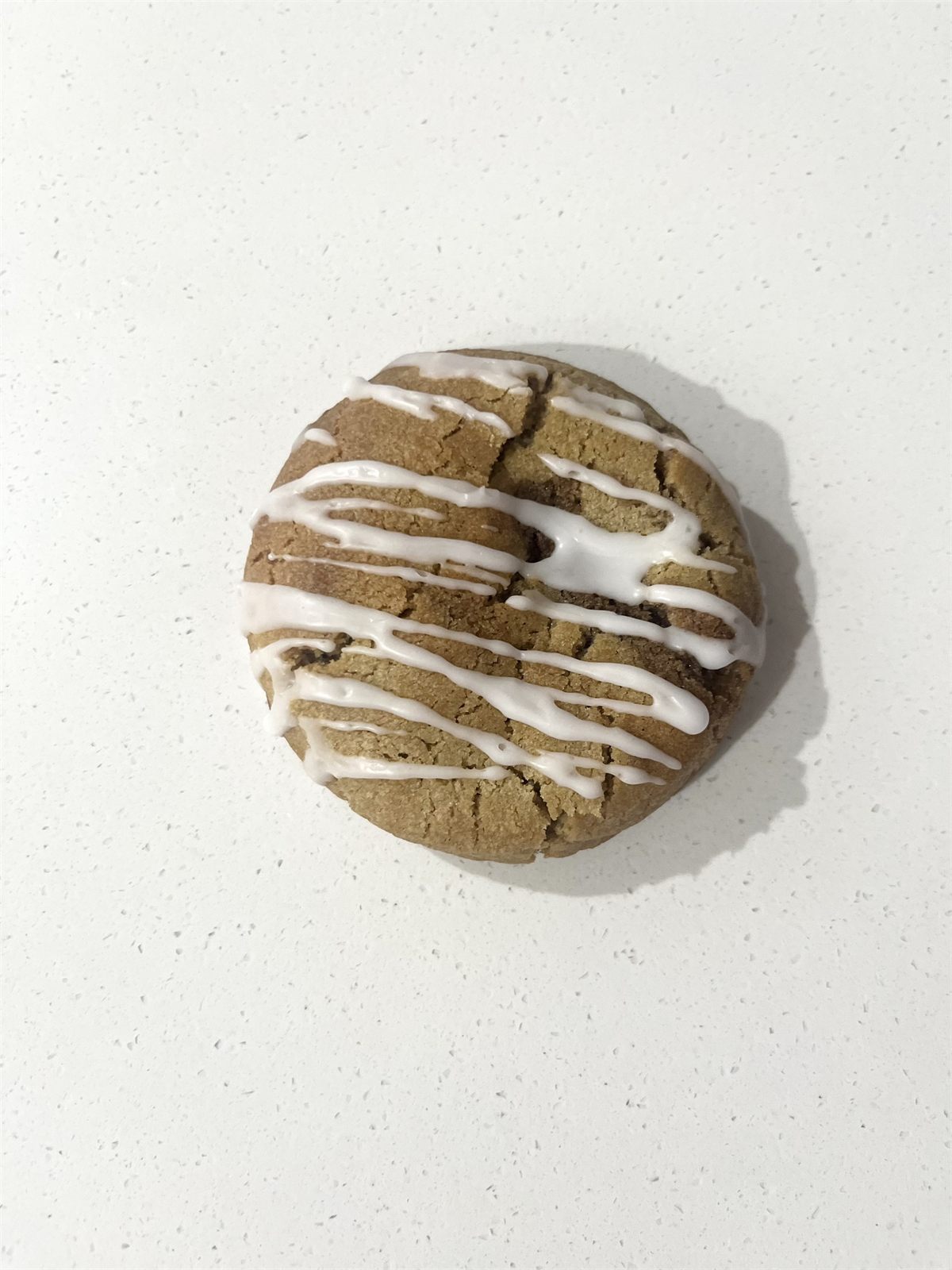 Cinnamon scroll swirl cookie with glaze drizzle